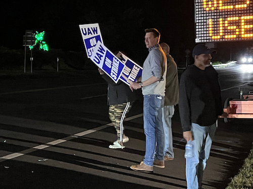 Photo of Josh standing in solidarity with UAW at the picket line in Tappan