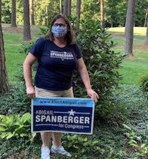 Volunteer with one of the many Abigail Spanberger signs across the district