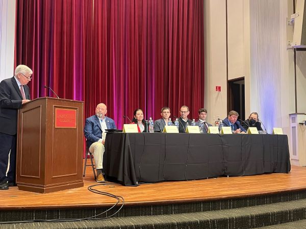 Photo of Carol Obando-Derstine at a candidate panel filled exclusively by white men.