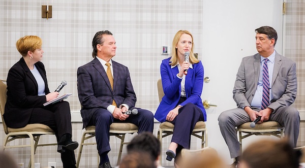 Photo of Brooke and speakers at the panel