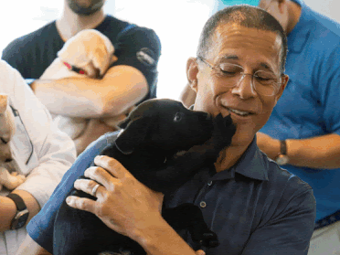 Anthony Brown holding a puppy.