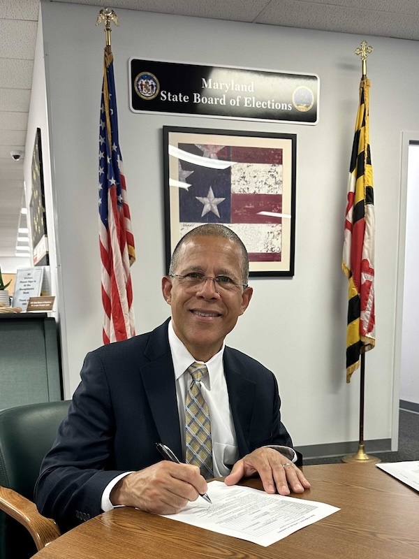 Anthony Brown signing his filing for re-election