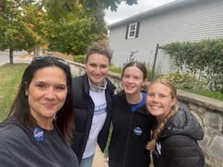 Picture of Callie with volunteers knocking on doors in MI-01