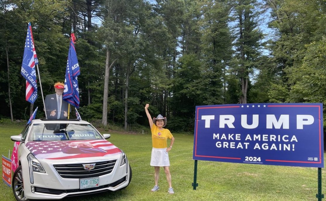 Republican Lily Tang Williams posing with Donald Trump merchandise.