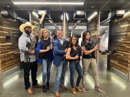 Beth Van Duyne and Lauren Boebert holding guns with a group of people