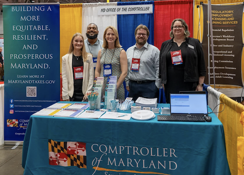 Photo of Brooke and others at the Comptroller's office booth