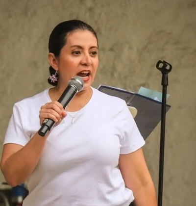 Carol speaking into microphone