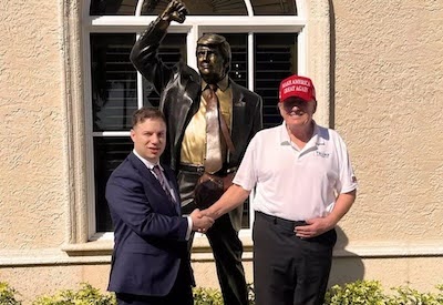Anthony Constantino and Donald Trump standing in front of a statue of Donald Trump