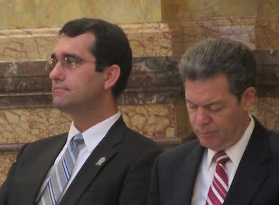 Representative Derek Schmidt sitting with former Governor Sam Brownback