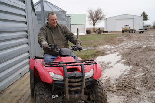 Jon Tester riding an ATV