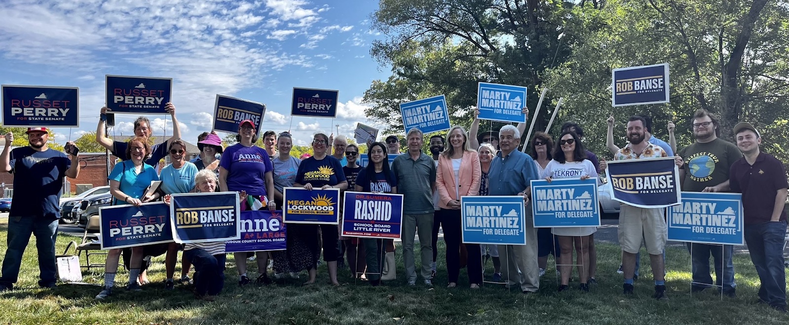 Abigail with local supporters holding yard signs.