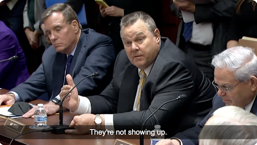 Image of Jon Tester speaking with caption "They're not showing up."