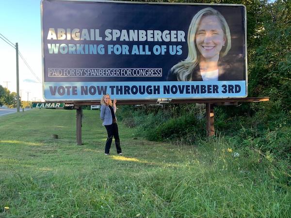 Abigail with one of our billboards! 