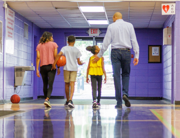 PHOTO OF JASON AND FAMILY ON THE COURT