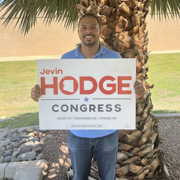 Jevin holding one of the yard signs