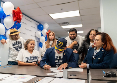 John and his family as he signs the paperwork to run for Congress in TX-35