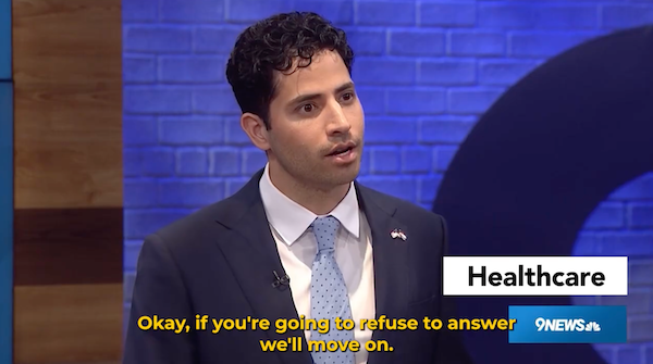 Photo of Manny Rutinel at the debate with the caption: "Okay, if you're going to refuse to answer we'll move on."
