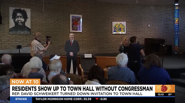 Screenshot of a news broadcast that says "Residents show up to town hall without Congressman"