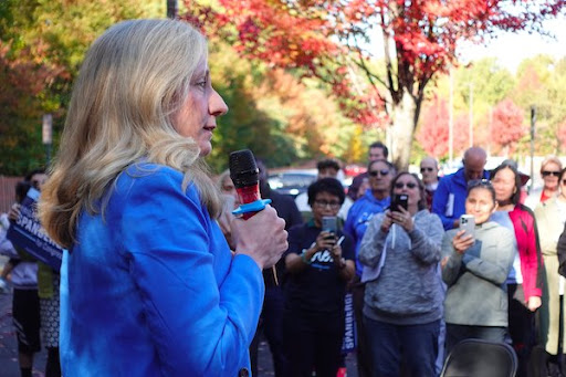 Abigail Spanberger holds a mic and speaks to her supporters.