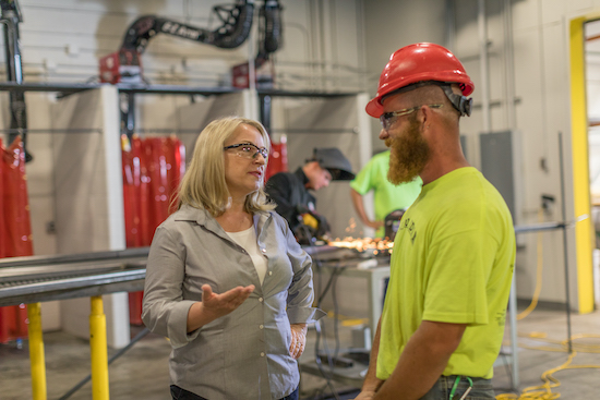 Susan Wild visiting a manufacturing facility