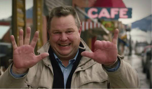 Jon Tester holding up his hands to show his missing fingers