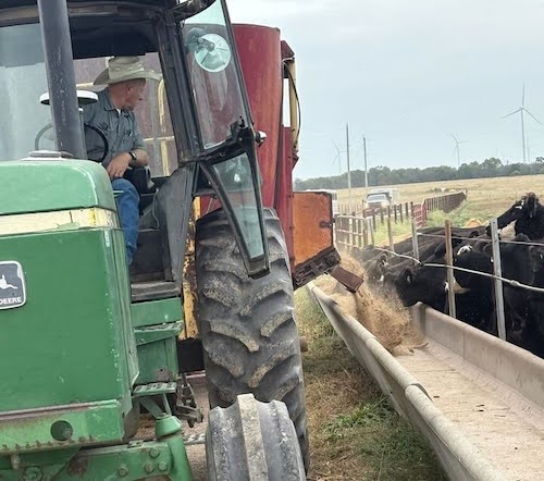 Picture of Don on his tractor, feeding cattle