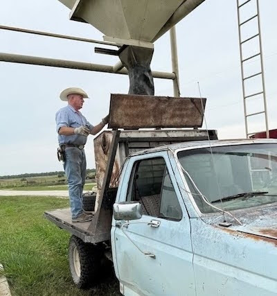 Picture of Don on a truck, doing work in the ranch