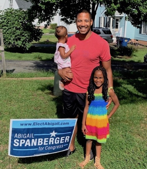 Family with yard sign in their lawn! Sign reads "Abigail Spanberger for Congress"